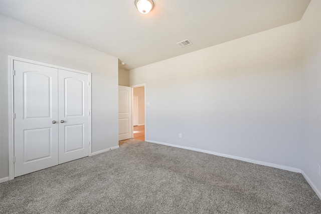 unfurnished bedroom featuring a closet and carpet