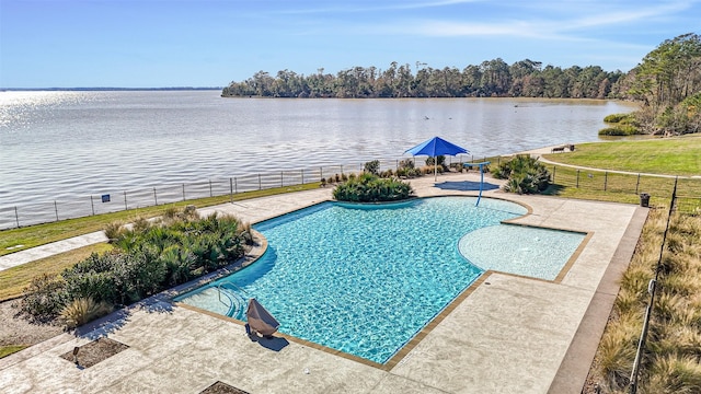 view of swimming pool featuring a water view and a patio area