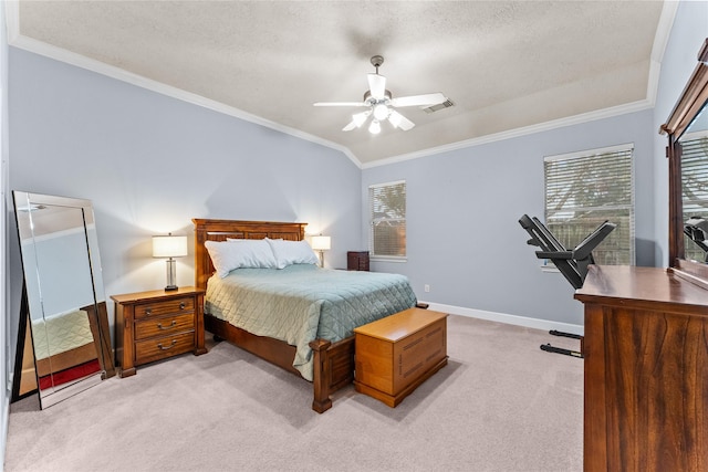 bedroom with ceiling fan, light colored carpet, ornamental molding, and a textured ceiling