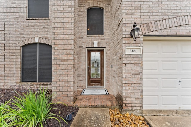 doorway to property with a garage