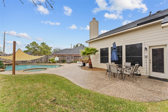 exterior space featuring an in ground hot tub, a yard, and a patio