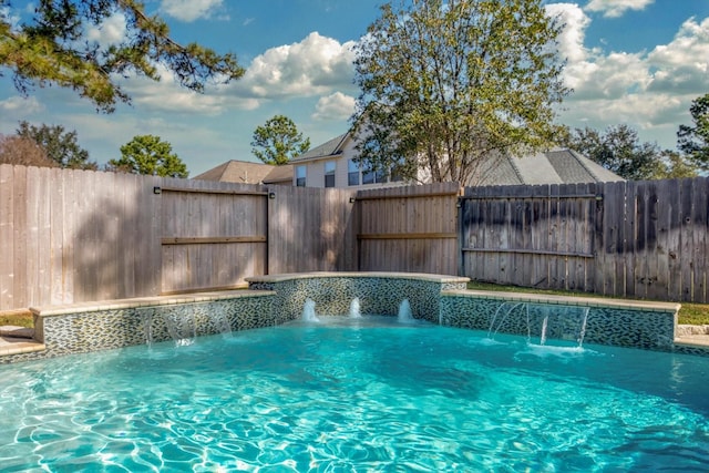 view of swimming pool with pool water feature