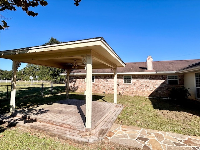 exterior space with a deck and ceiling fan