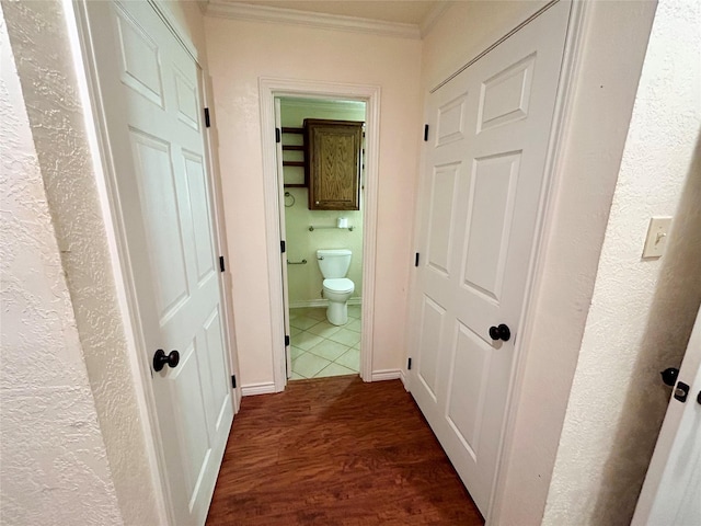 hall featuring dark wood-type flooring and ornamental molding