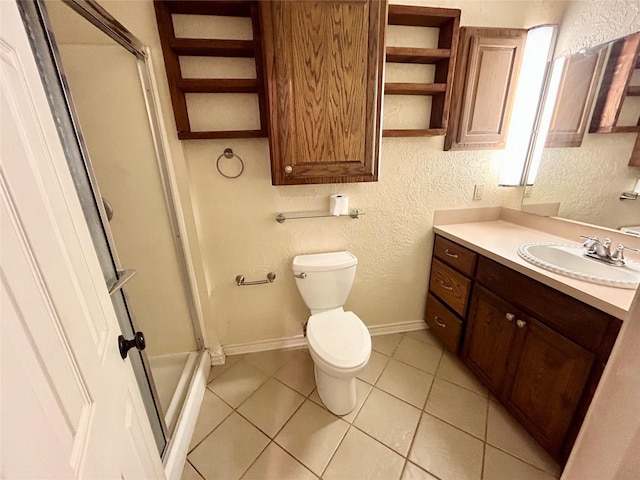 bathroom featuring vanity, toilet, tile patterned flooring, and walk in shower