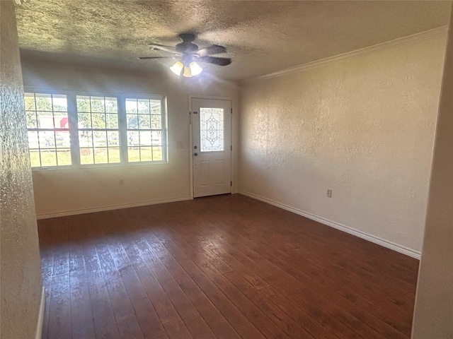 unfurnished room with ceiling fan, a textured ceiling, dark hardwood / wood-style floors, and ornamental molding