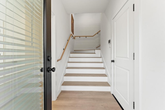 stairway featuring wood-type flooring