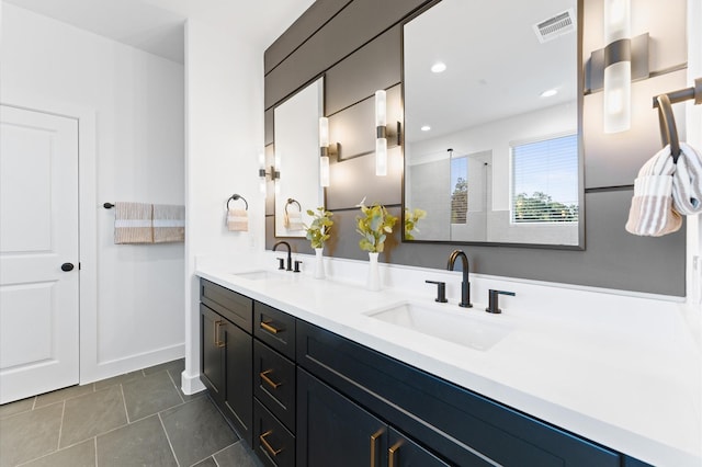 bathroom featuring vanity, tile patterned floors, and walk in shower