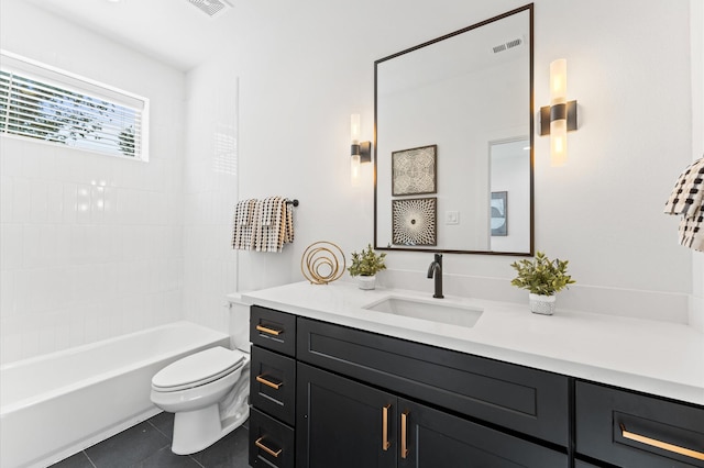 full bathroom with vanity, toilet, tiled shower / bath combo, and tile patterned flooring