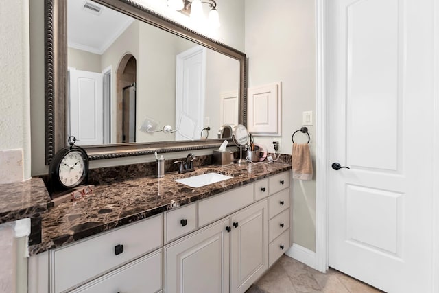 bathroom featuring vanity, tile patterned floors, and crown molding