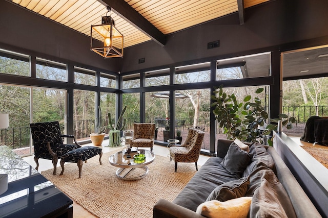 sunroom with wooden ceiling, plenty of natural light, and lofted ceiling with beams