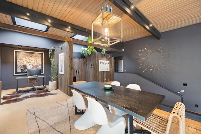 dining room with track lighting and beamed ceiling