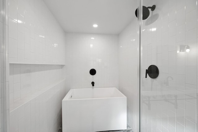 bathroom with separate shower and tub and tile walls