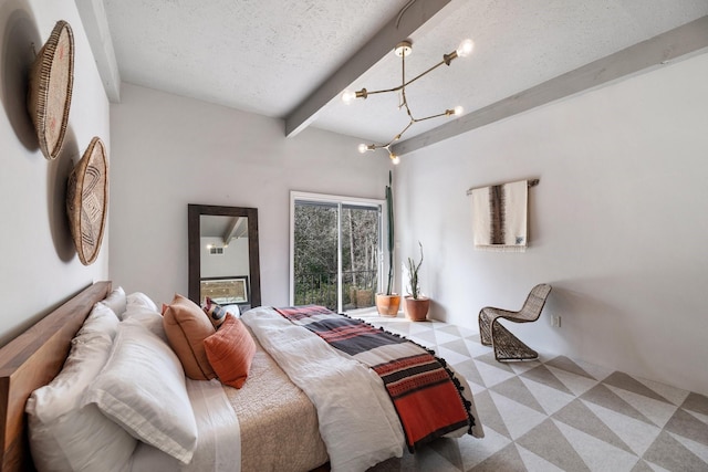 bedroom with a textured ceiling, beam ceiling, and an inviting chandelier