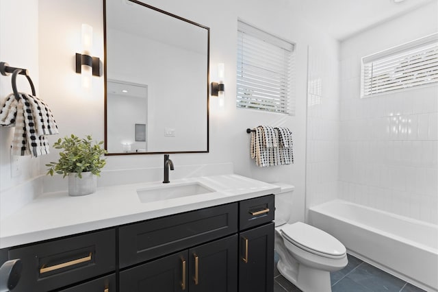 full bathroom featuring tile patterned flooring, vanity, tiled shower / bath combo, and toilet