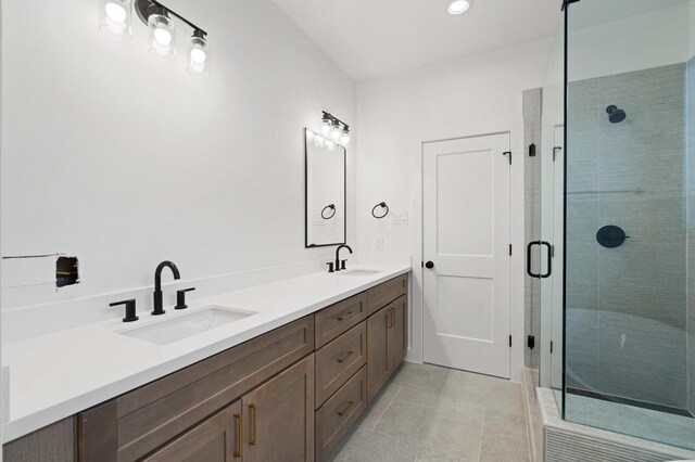 bathroom featuring vanity, an enclosed shower, and tile patterned floors