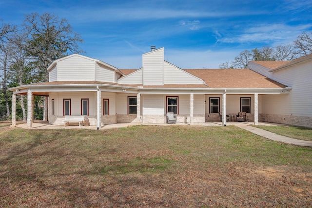 rear view of house with a yard