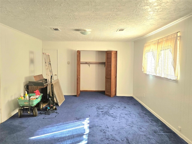 unfurnished bedroom featuring a textured ceiling, a closet, and carpet