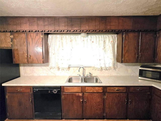 kitchen featuring sink, a textured ceiling, black dishwasher, and wooden walls