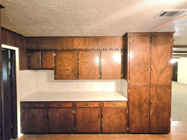 kitchen with a textured ceiling and wood walls