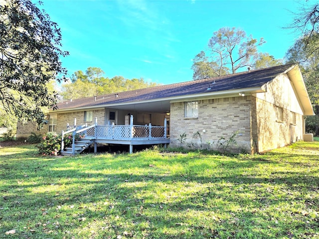 back of property featuring a lawn and a deck