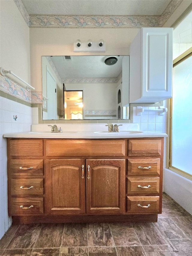 bathroom with enclosed tub / shower combo and vanity