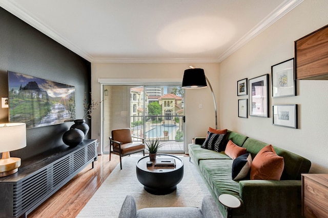 living room with crown molding and light wood-type flooring