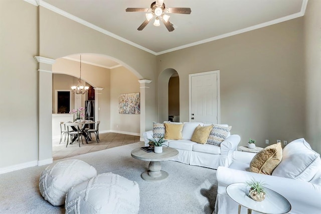 living room featuring light tile patterned floors, ceiling fan with notable chandelier, crown molding, and decorative columns