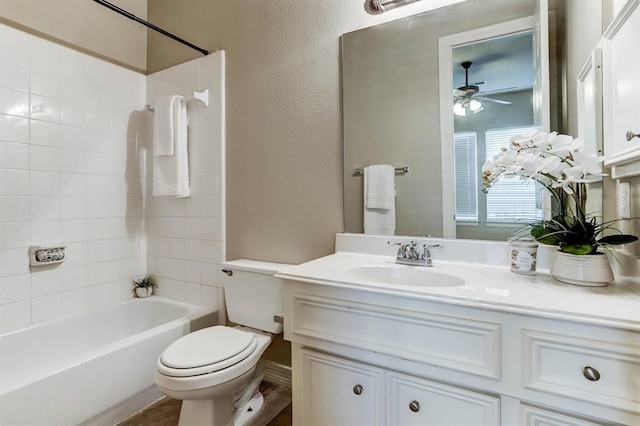 full bathroom with ceiling fan, shower / bathing tub combination, vanity, and toilet