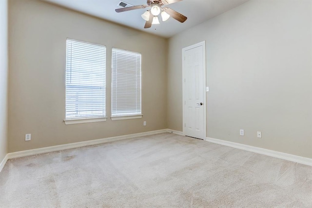 carpeted spare room featuring ceiling fan