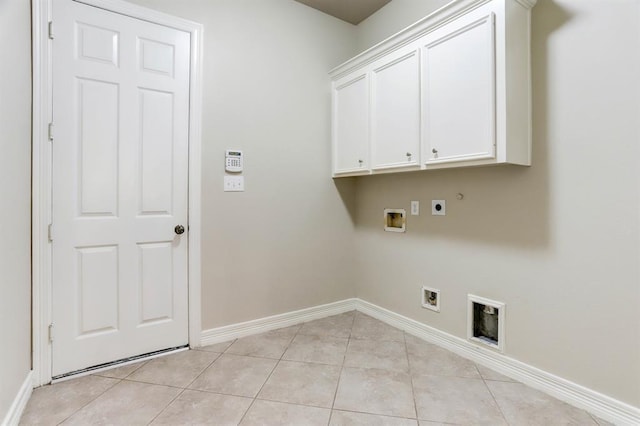 clothes washing area featuring cabinets, washer hookup, hookup for an electric dryer, light tile patterned floors, and gas dryer hookup