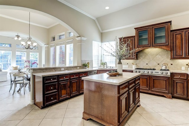 kitchen featuring tasteful backsplash, stainless steel gas stovetop, hanging light fixtures, and a center island