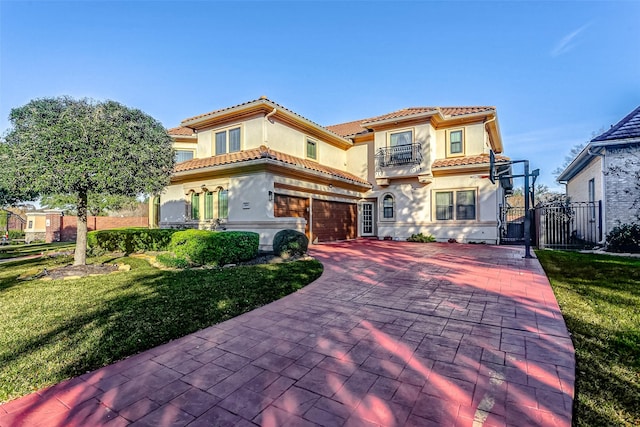 mediterranean / spanish-style house with a front lawn, a balcony, and a garage