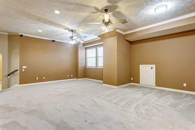 carpeted empty room featuring ceiling fan, a textured ceiling, and crown molding