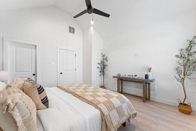 bedroom with ceiling fan, high vaulted ceiling, and light wood-type flooring