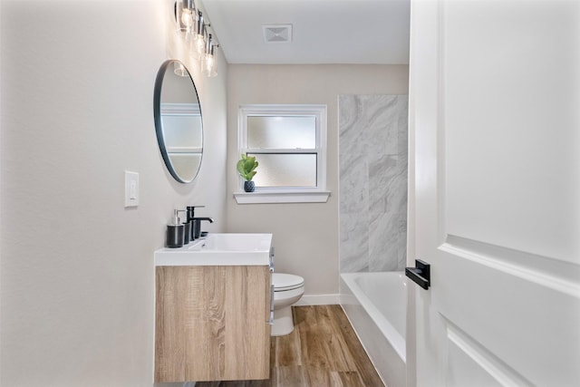 bathroom featuring toilet, vanity, and hardwood / wood-style floors