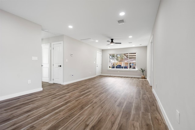 unfurnished living room with dark wood-type flooring and ceiling fan