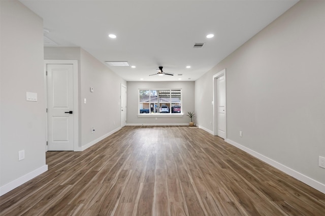 unfurnished living room with dark wood-type flooring and ceiling fan