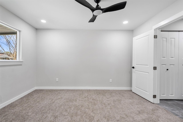 unfurnished bedroom featuring ceiling fan, a closet, and carpet flooring