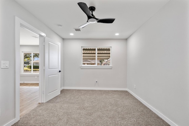 carpeted spare room with ceiling fan