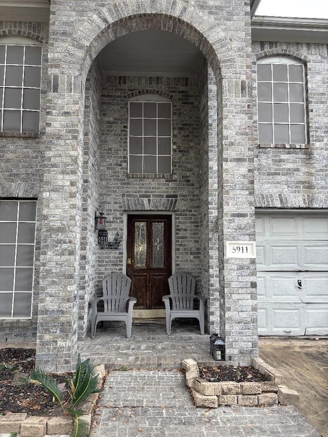 view of exterior entry with a garage