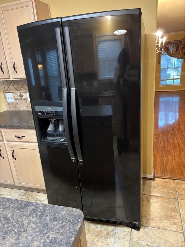 kitchen featuring tasteful backsplash, black refrigerator with ice dispenser, and light brown cabinets