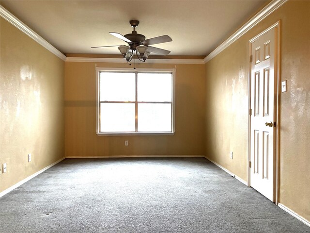 carpeted spare room with crown molding and ceiling fan