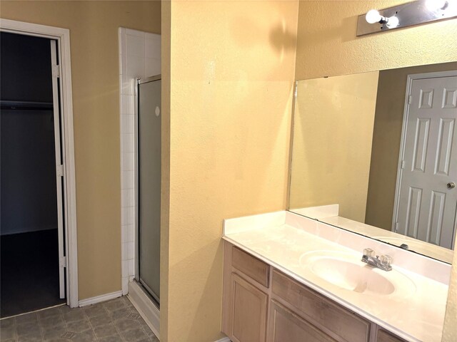 bathroom featuring vanity and an enclosed shower