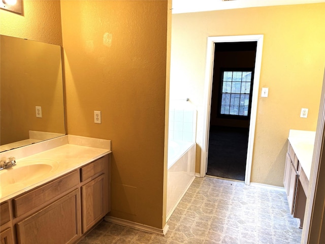 bathroom featuring vanity and a relaxing tiled tub