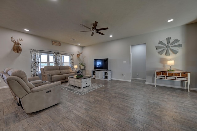 living room featuring ceiling fan and wood-type flooring