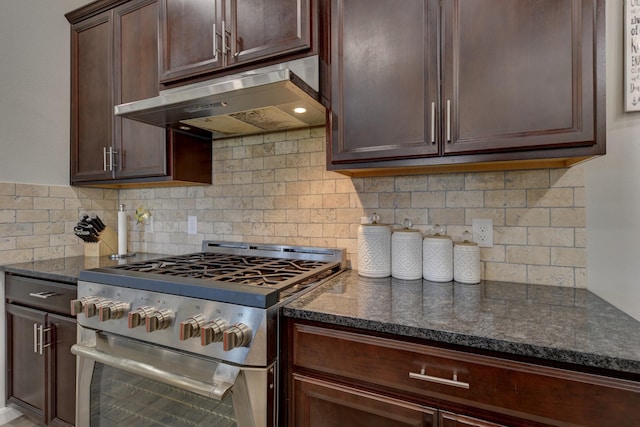 kitchen featuring decorative backsplash, dark brown cabinets, gas stove, and dark stone countertops