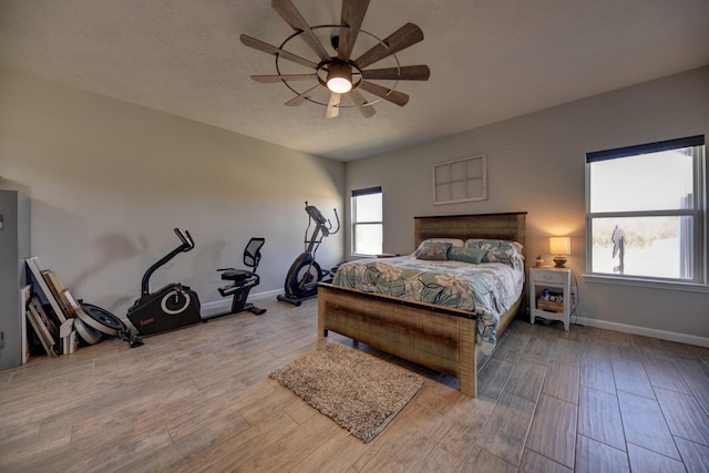 bedroom with ceiling fan and light hardwood / wood-style flooring