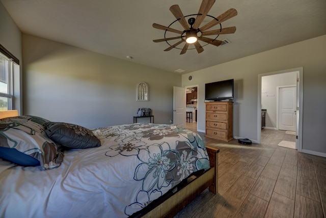 bedroom featuring ceiling fan and ensuite bathroom