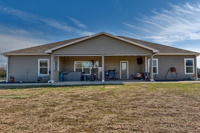 rear view of property with a patio area and a lawn